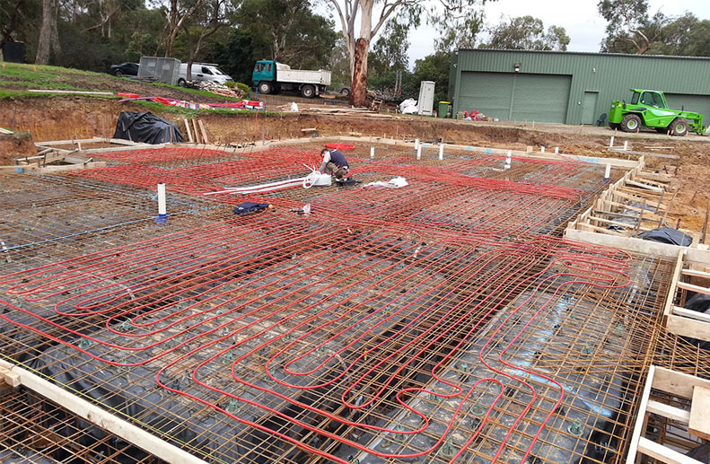 A Large double storey home with Red Rehau hydronic Pex A pipe before concrete pour for Hydronic heating system in Lower Plenty