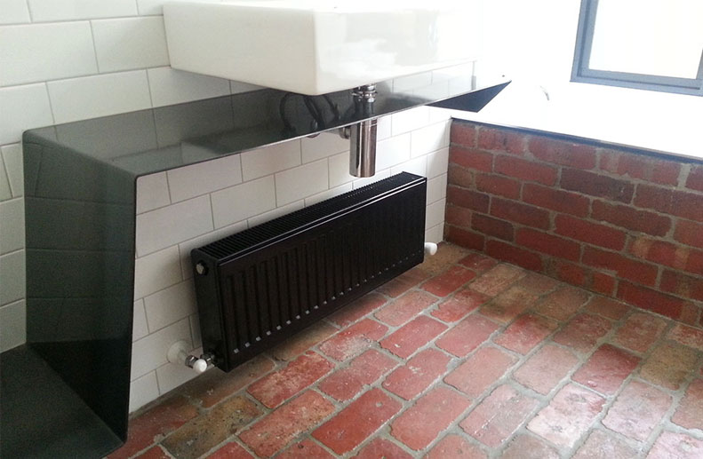 An architect designed renovation in Fitzroy with Bosch Condensing Boiler and custom black De Longhi panels.