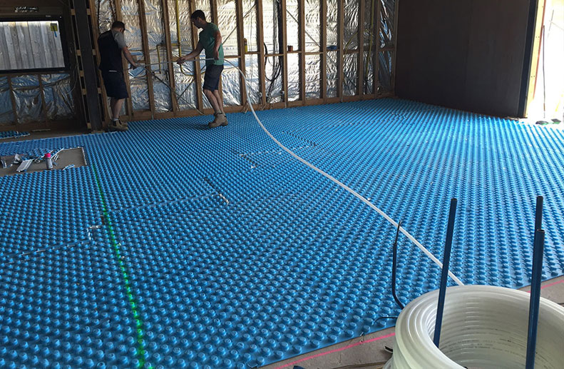 Blue Foam positioning board was used in this architecturally designed home with white Pex B Hydronic pipe. There were 2 Immergas Boilers, one for the downstairs In Slab (screed) installation and the other for the upstairs panels as the home was very large. Green paint indicates the construction joins within the slab and the kitchen bend and cabinets.