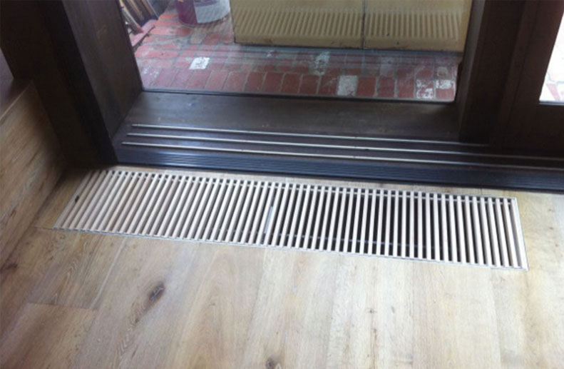 A custom Jaga trench convector was installed in front of the fixed pane of glass in an Architects home. The top grille timber was Oak to match the finished floor boards. The rest of the installation had De Longhi Steel radiator panels and a Bosch Condensing boiler.