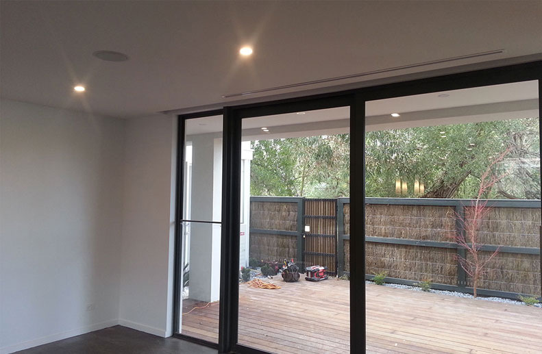 townhouses in Sandringham with Small Duct Systems fan coils installed into bulkhead at the rear of garage and Immergas hydronic condensing boilers with Lennox air cons. The solid duct is 250mm and the flexible duct is only 100mm allowing installation with minimal clearance installed to custom single slot linear grilles.