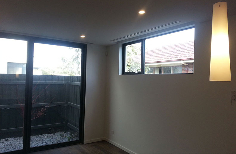 townhouses in Sandringham with Small Duct Systems fan coils installed into bulkhead at the rear of garage and Immergas hydronic condensing boilers with Lennox air cons. The solid duct is 250mm and the flexible duct is only 100mm allowing installation with minimal clearance installed to custom single slot linear grilles.