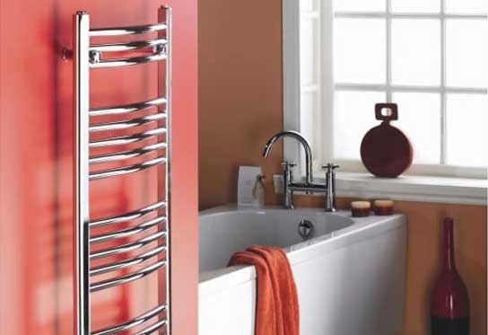 curved crome towel rack hydronic heater wall radiator panel against red wall