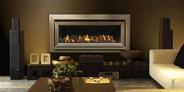 ESCEA DL1100 indoor fireplace using gas with silver border built on to a brown wall in a lounge room