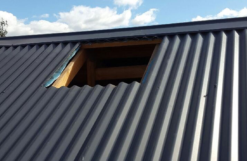 Coolbreeze Evaporative cooling being installed on a Colorbond roof - QAD 125 Slate Grey