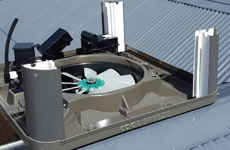 Coolbreeze Evaporative cooling being installed on a Colorbond roof - QAD 125 Slate Grey