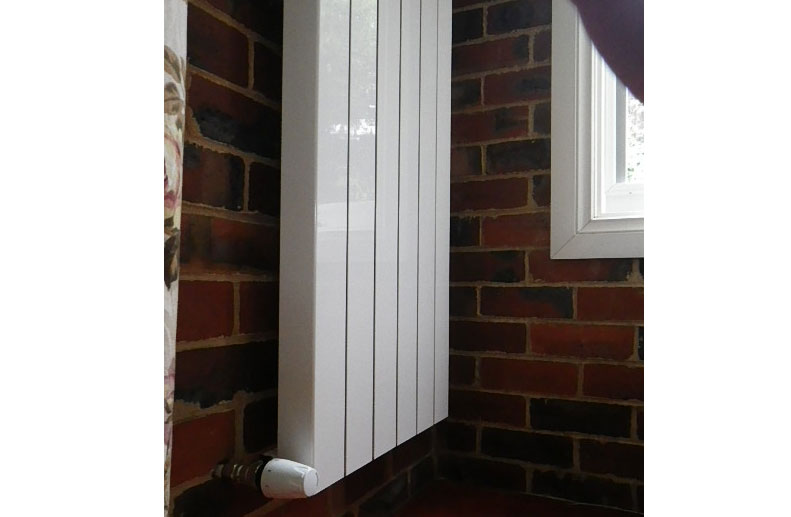Hydronic heating radiator panels had vertical aluminium “Oscar” radiator panels to fit between the limited width wall space in croydon home
